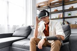 A person using virtual reality equipment to experience different types of virtual reality. Learn about 7 types of VR experiences and their applications in various industries. Embrace the possibilities of virtual reality technology. by CG Viz Studio