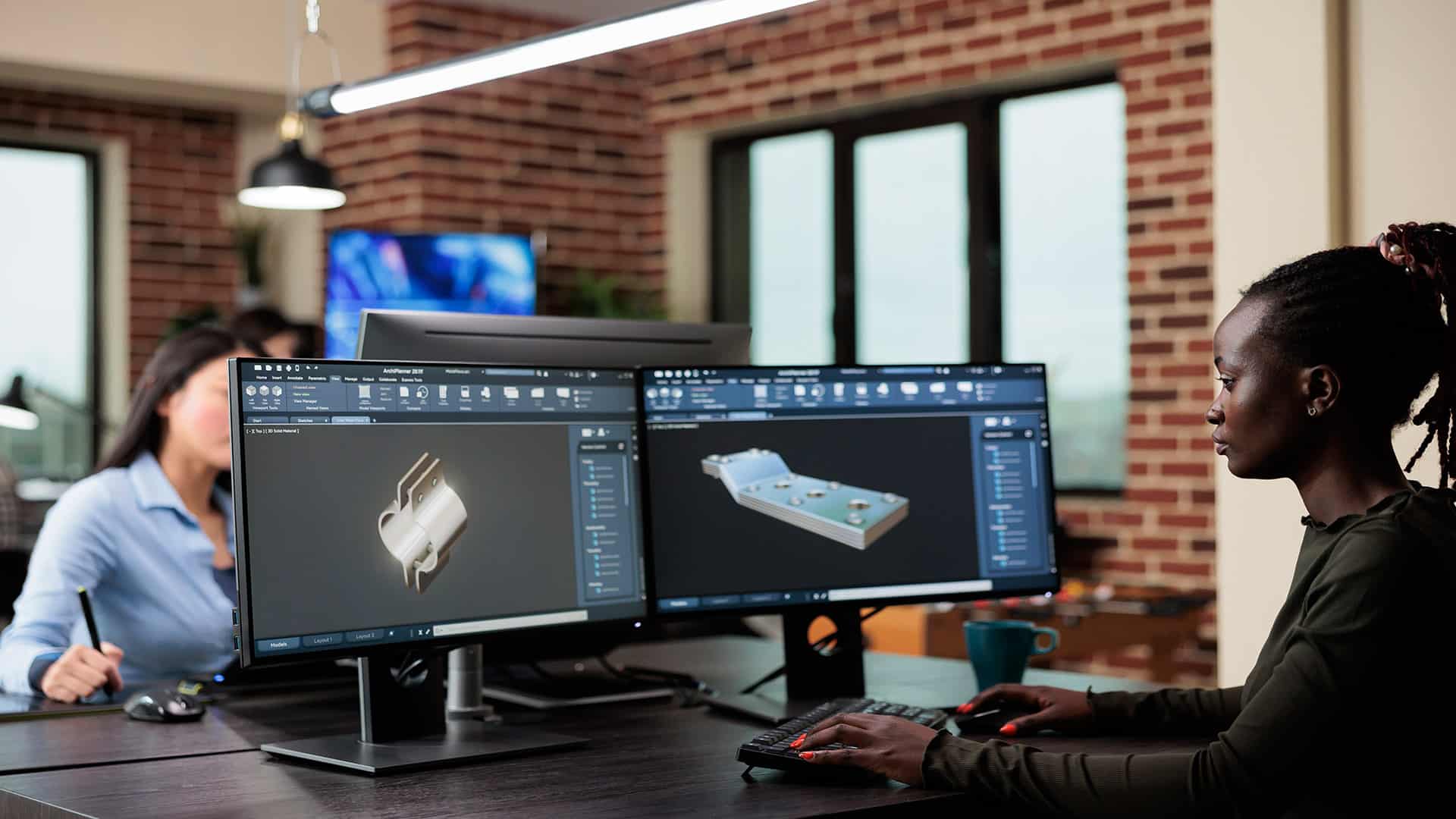 A 3D modeler working on a computer, creating a digital 3D object.